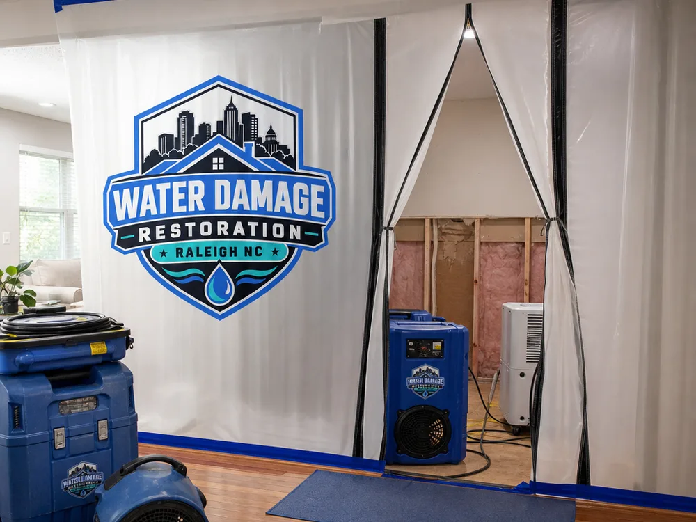Contained work area with a zipper door, air scrubber, dehumidifier, and partially opened wall cavity